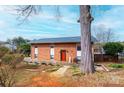 Attractive brick home with a red front door and stone walkway, surrounded by mature trees at 1285 Riverview Dr, Hickory, NC 28602