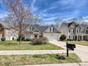 Inviting two-story home with a two-car garage, lovely landscaping, and a welcoming driveway at 1394 Fitzgerald Nw St, Concord, NC 28027