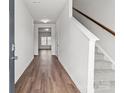 Inviting entryway with hardwood floors, white walls, and carpeted stairs to the second floor at 142 S Bell Ave, Albemarle, NC 28001