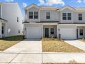 Charming townhome with a one car garage, well maintained lawn, and attractive front door at 142 S Bell Ave, Albemarle, NC 28001