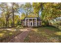 Charming brick home with black shutters, a columned portico and walkway at 14725 N Old Statesville Rd, Huntersville, NC 28078