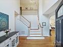Open foyer with hardwood floors, staircase, and tall ceilings for an airy, spacious feel at 15715 Holyhead Ln, Huntersville, NC 28078