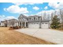 Beautiful two-story home with a three-car garage and manicured front lawn at 158 Country Lake Dr, Mooresville, NC 28115