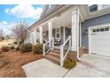 Inviting front porch with brick steps, columns, and comfortable seating at 158 Country Lake Dr, Mooresville, NC 28115