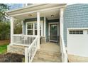 Inviting front porch features stone accents, stylish seating, and a welcoming entrance at 18607 Mainsail Ct, Lancaster, SC 29720