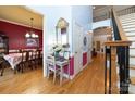 Open foyer with hardwood flooring, stairs, wrought iron railing and dining room view offer inviting, elegant entry at 205 Kaitlyn Ln, Kings Mountain, NC 28086