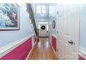 Bright and airy foyer with hardwood floors, staircase and white trim, leading to the front door at 205 Kaitlyn Ln, Kings Mountain, NC 28086