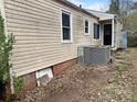 Backyard view of the home's siding, showing the back door entrance and air conditioning unit at 220 Valleyview Pl, Salisbury, NC 28144