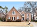 Traditional brick home with mature trees and an expansive front yard at 2300 Bonnie Butler Way, Charlotte, NC 28270