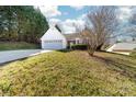 Charming home featuring an attached two-car garage, white siding, and a well-maintained front yard with lush greenery at 2359 Eagle Glen Ct, Gastonia, NC 28056