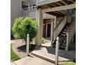 Exterior view of a building entrance with a wooden staircase and landscaped greenery at 2545 Stockbridge Dr, Charlotte, NC 28210