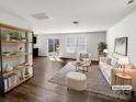 Bright living room features an open floor plan, wood floors, and plenty of natural light from sliding glass doors at 2609 Riley Woods Ln, Charlotte, NC 28269