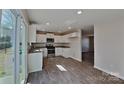 Modern kitchen featuring white cabinets, granite countertops, and stainless steel appliances at 299 Berrybeth Cir, China Grove, NC 28023