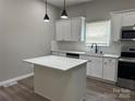 Open concept kitchen with white cabinetry, stainless appliances, quartz counters, and a convenient center island at 3342 York Hwy, Gastonia, NC 28052