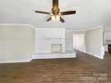 Bright living room featuring a brick fireplace, ceiling fan and light colored walls at 414 N Wylie St, Lancaster, SC 29720