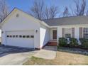 Close up of a charming single story home with an attached two car garage and manicured landscaping at 439 Berwick Dr, Rock Hill, SC 29730