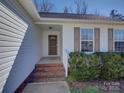Close up of home featuring a charming front porch with decorative shutters and brick entryway at 439 Berwick Dr, Rock Hill, SC 29730