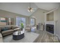 Bright living room featuring a fireplace, sliding glass doors, ceiling fan and modern flooring at 439 Berwick Dr, Rock Hill, SC 29730