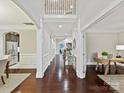 Spacious foyer with hardwood floors, staircase and architectural details at 4624 Pebble Run Dr, Matthews, NC 28105