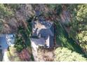Aerial view of the home with a well-manicured lawn and mature trees surrounding the property at 4763 River Hills Dr, Denver, NC 28037