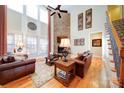 Spacious living room with a stone fireplace, hardwood floors, and ample natural light at 4763 River Hills Dr, Denver, NC 28037