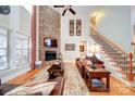 Bright living room with a stone fireplace, soaring ceilings, and hardwood floors at 4763 River Hills Dr, Denver, NC 28037