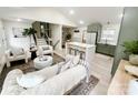 Open concept living and kitchen with island, neutral paint colors, and wood floors at 5057 Murrayhill Rd, Charlotte, NC 28210