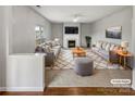 Bright living room features stylish furniture, a cozy fireplace, and a large area rug at 5810 Dove Point Sw Dr, Concord, NC 28025