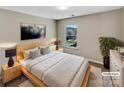 Relaxing bedroom with plush bedding, bedside tables, lamps, and a lovely window view at 5810 Dove Point Sw Dr, Concord, NC 28025
