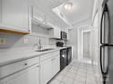 Bright kitchen with a stainless steel sink, sleek black appliances, and ample counter space at 7415 Mystic Ln, Charlotte, NC 28227