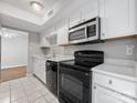 Kitchen featuring ample counter space, stainless steel microwave, and black appliances at 7415 Mystic Ln, Charlotte, NC 28227