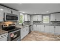 Modern kitchen featuring stainless steel appliances, granite counters, and stylish tile backsplash at 98 Ring Sw Ave, Concord, NC 28025