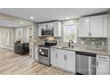 A lovely kitchen featuring stainless steel appliances, granite countertops, and white cabinets for a bright, modern look at 98 Ring Sw Ave, Concord, NC 28025