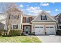 Charming two-story home featuring a two-car garage, stone accents, and manicured landscaping at 10153 Elizabeth Crest Ln, Charlotte, NC 28277