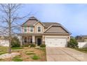 Inviting two-story home with a two car garage, well-maintained lawn, and a welcoming porch at 10605 Three Rivers Ct, Charlotte, NC 28273
