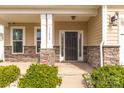 Covered front porch with stone accents, modern lighting, house number and black front door at 10605 Three Rivers Ct, Charlotte, NC 28273