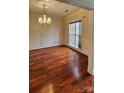 Elegant dining room with hardwood floors, crown molding, and a stylish chandelier at 10607 Old Bridge Ln, Charlotte, NC 28269