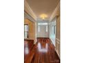 Inviting foyer with hardwood floors, wainscoting, and a view of the living spaces at 10607 Old Bridge Ln, Charlotte, NC 28269