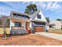 Beautiful two-story home with a modern garage and covered porch on a sunny day at 1210 Skyview Rd, Charlotte, NC 28208