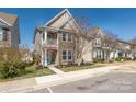 Charming two-story home with stone facade, a blue front door, and well-maintained landscaping at 13925 Helen Benson Blvd, Davidson, NC 28036