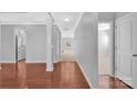Spacious hallway with wood flooring, gray walls, and white trim leading to carpeted rooms at 141 Planters Dr, Statesville, NC 28677