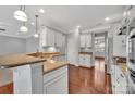 Open kitchen design boasting granite countertops, a breakfast bar, and white cabinets at 141 Planters Dr, Statesville, NC 28677