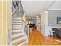 Bright foyer showcasing hardwood floors, a staircase with white railings, and an open floor plan at 142 Mills Ln, Fort Mill, SC 29708