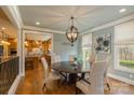 Charming dining room with hardwood floors and a view of the adjacent kitchen, creating a cozy atmosphere at 1426 Merrimont Ave, Kings Mountain, NC 28086