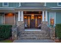 Inviting front porch with stone accents, decorative wreath, and seating, perfect for relaxing at 1426 Merrimont Ave, Kings Mountain, NC 28086