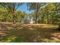 Large, grassy backyard with mature trees provides ample space for outdoor activities at 1513 Fletcher Broome Rd, Monroe, NC 28112