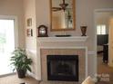 Elegant fireplace with tile surround, decorative mantel, and a view into the bedroom at 17811 Half Moon Ln, Cornelius, NC 28031