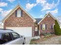 Brick home with an attached garage, a landscaped yard, and a silver car in the driveway at 1896 Independence Sq, Kannapolis, NC 28081