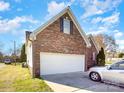 Brick home featuring an attached garage with a silver car partially visible at 1896 Independence Sq, Kannapolis, NC 28081