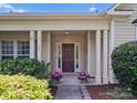 Inviting front porch with classic columns and decorative plants creating a warm welcome at 196 Gabriel Dr, Mooresville, NC 28115